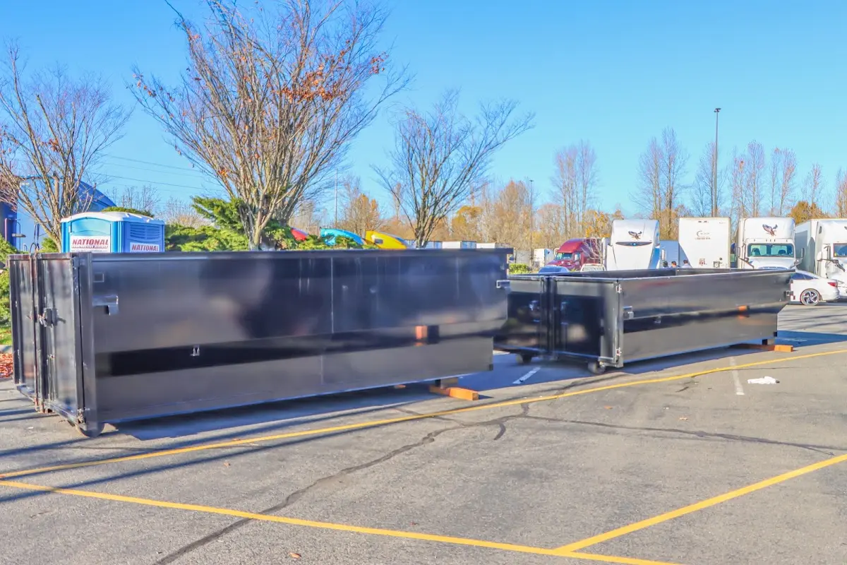 Professional dumpster rental service with roll-off container on residential driveway in Villa Rica